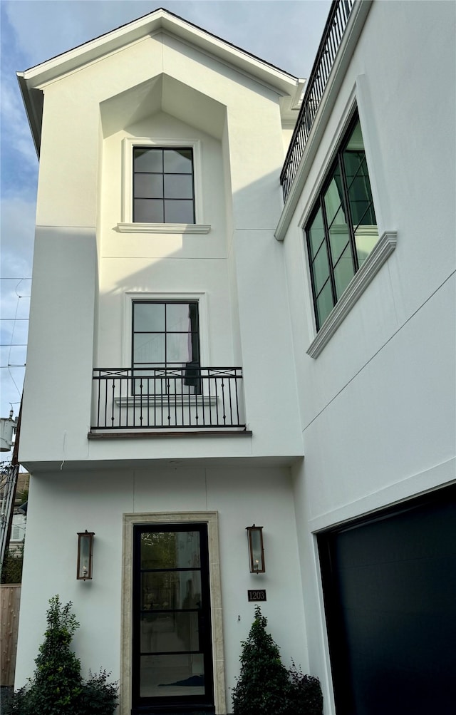 exterior space featuring a balcony and a garage