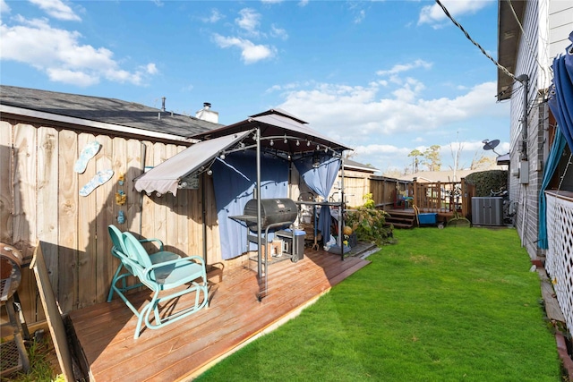 exterior space with central air condition unit, a gazebo, and a wooden deck