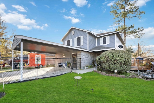 back of house with a yard and a carport