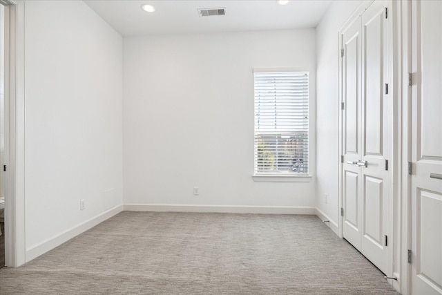 unfurnished bedroom with carpet, visible vents, baseboards, and recessed lighting