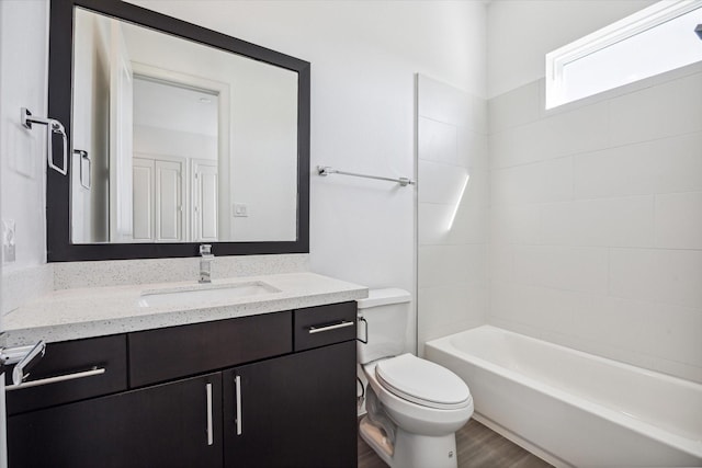 bathroom featuring tub / shower combination, vanity, toilet, and wood finished floors