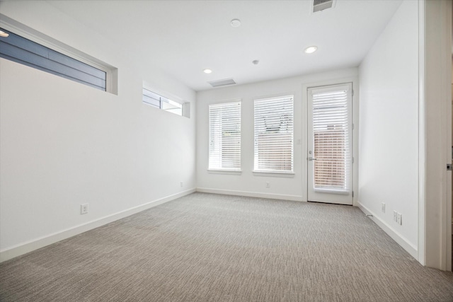 empty room with recessed lighting, carpet, visible vents, and baseboards