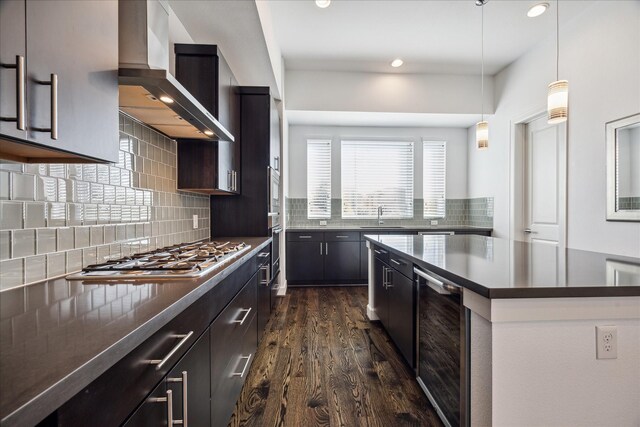 kitchen with dark wood-style floors, wine cooler, stainless steel appliances, tasteful backsplash, and wall chimney range hood