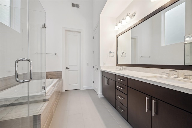 bathroom featuring tile patterned flooring, vanity, and independent shower and bath