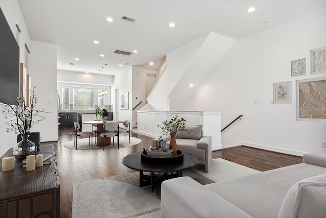 living room with hardwood / wood-style floors and a notable chandelier