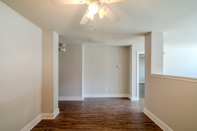 spare room featuring a textured ceiling, ceiling fan, and dark hardwood / wood-style floors