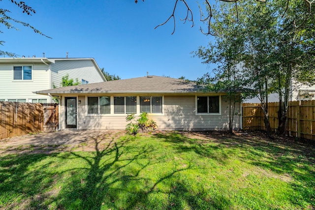 back of house with a yard and a patio area