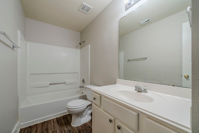 full bathroom featuring hardwood / wood-style floors, vanity, toilet, and shower / washtub combination