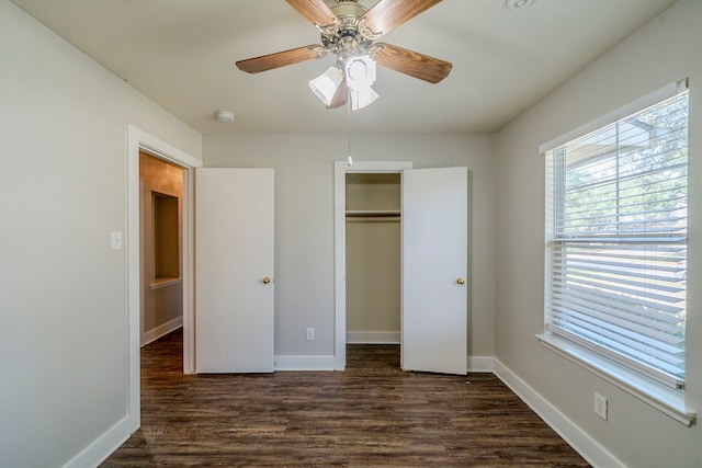 unfurnished bedroom with a closet, ceiling fan, and dark wood-type flooring