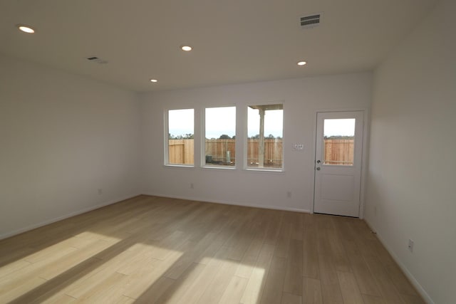 unfurnished room with light hardwood / wood-style flooring