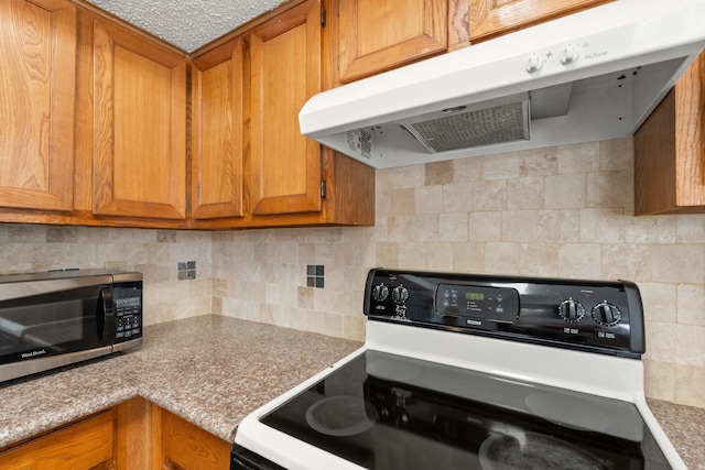 kitchen with white range with gas cooktop and decorative backsplash