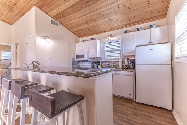 kitchen with white appliances, white cabinets, decorative backsplash, lofted ceiling, and wood ceiling