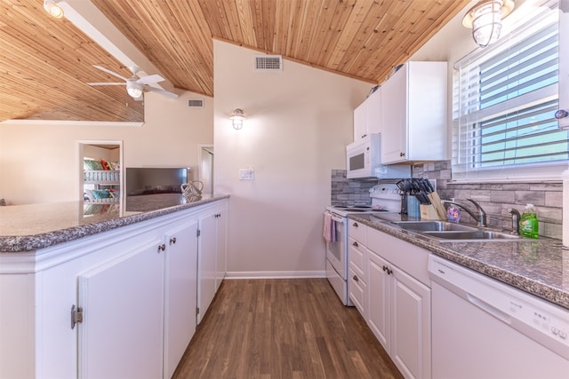 kitchen featuring visible vents, a sink, white appliances, decorative backsplash, and lofted ceiling