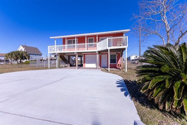 view of front of home with a garage and a carport