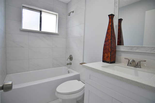 full bathroom with vanity, tiled shower / bath combo, and toilet