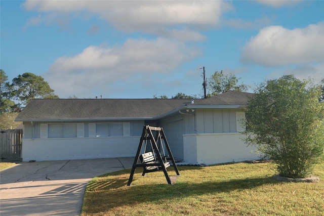 single story home with a garage and a front yard