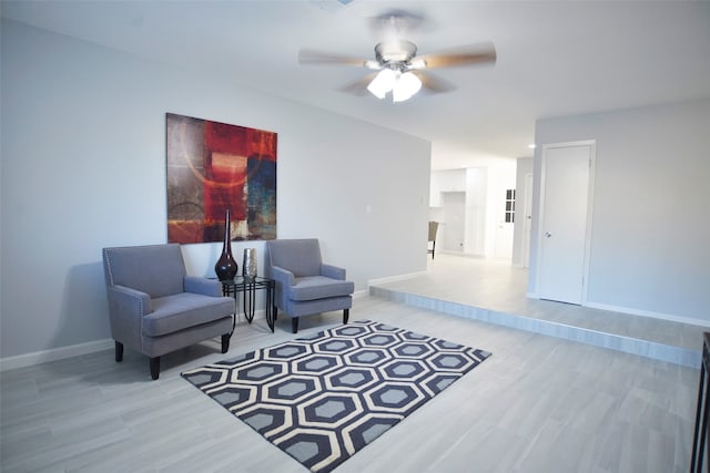 sitting room featuring ceiling fan