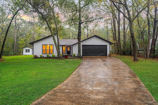 view of front of property with a yard and a garage