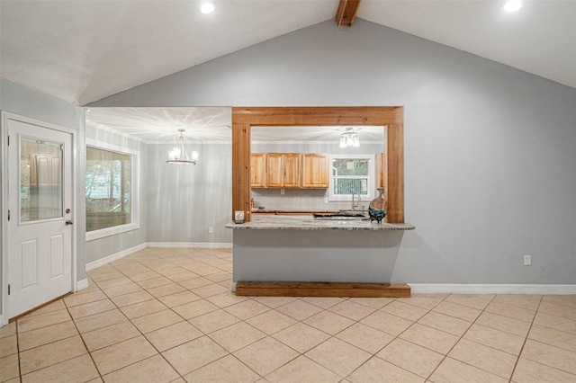 unfurnished living room with a chandelier, light tile patterned floors, vaulted ceiling with beams, and sink