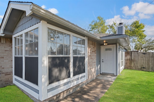 doorway to property with a yard