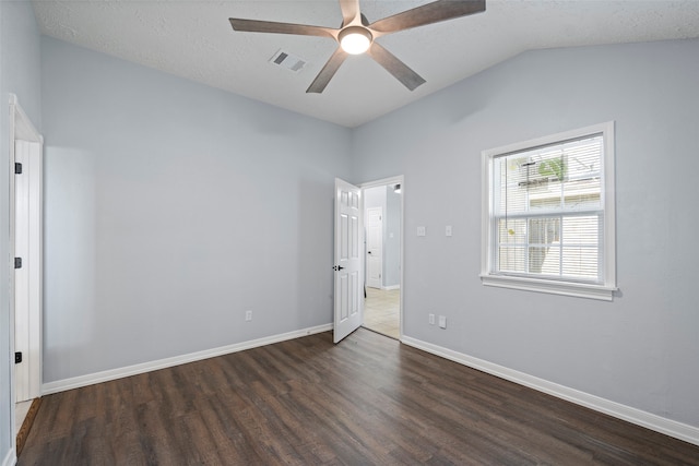 unfurnished bedroom featuring vaulted ceiling, ceiling fan, a textured ceiling, and dark hardwood / wood-style floors