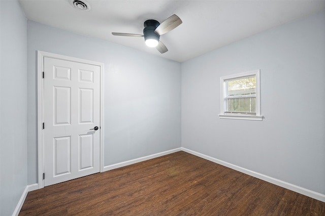 unfurnished room with ceiling fan and dark hardwood / wood-style flooring