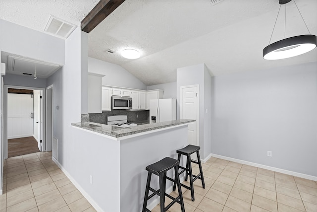 kitchen featuring kitchen peninsula, decorative backsplash, white appliances, stone counters, and white cabinetry