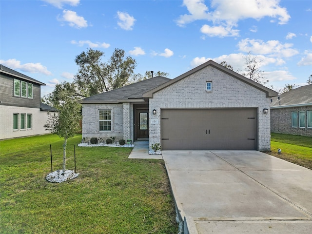 view of front of home with a front yard and a garage