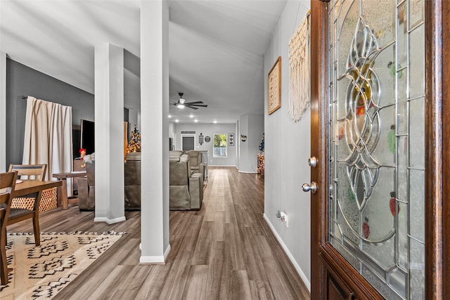 entrance foyer with hardwood / wood-style flooring, decorative columns, and ceiling fan