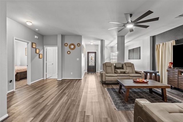 living room with ceiling fan and hardwood / wood-style floors