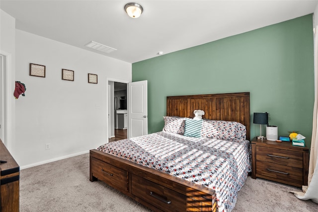 bedroom featuring light colored carpet