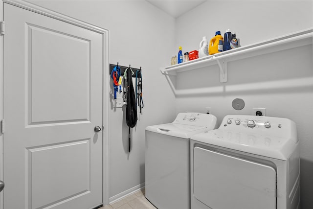 laundry room with light tile patterned floors and independent washer and dryer