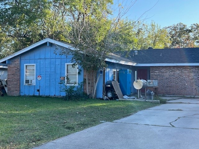 back of house featuring a yard and cooling unit