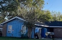 rear view of property featuring a lawn