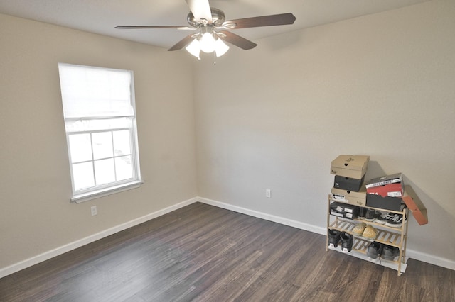 empty room with ceiling fan and dark wood-type flooring