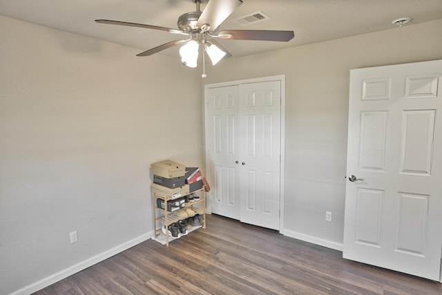 bedroom with a closet, ceiling fan, and dark hardwood / wood-style flooring