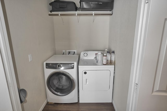 washroom featuring dark hardwood / wood-style floors and washing machine and dryer