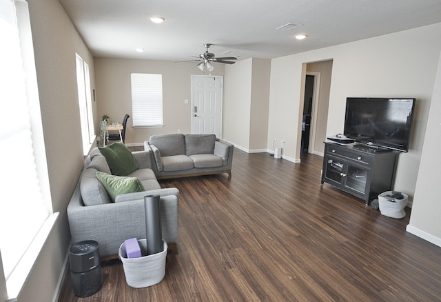 living room featuring dark hardwood / wood-style floors and ceiling fan