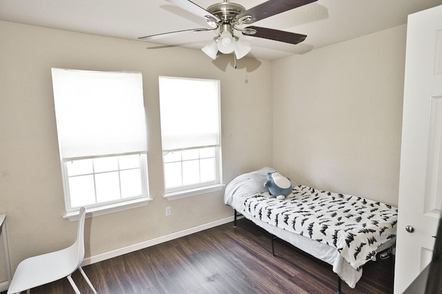 bedroom with dark hardwood / wood-style flooring, multiple windows, and ceiling fan