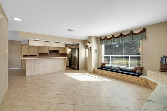 unfurnished living room featuring light tile patterned flooring