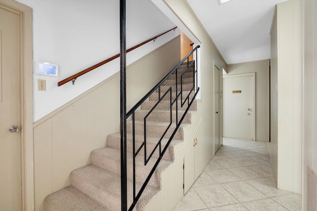 stairway with tile patterned flooring