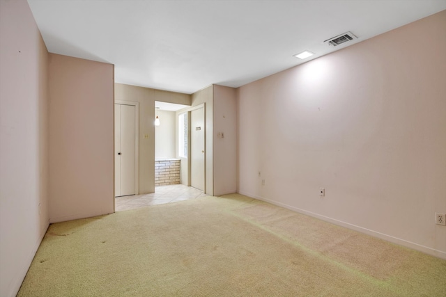 empty room featuring light carpet