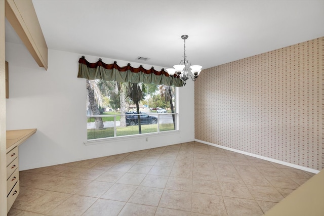 unfurnished dining area featuring an inviting chandelier