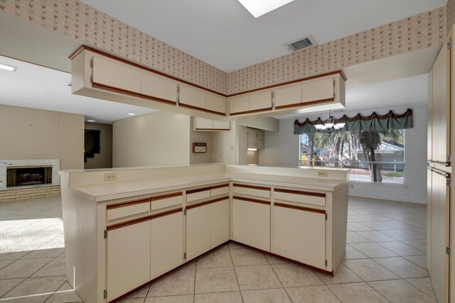 kitchen featuring kitchen peninsula and light tile patterned floors