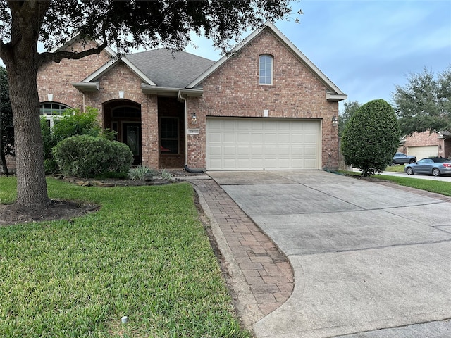 front of property featuring a front yard and a garage