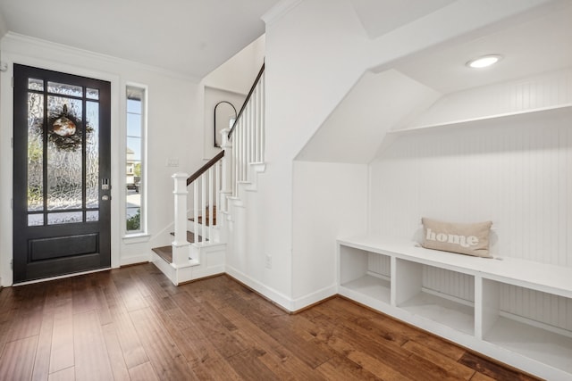 entryway with dark hardwood / wood-style flooring and ornamental molding