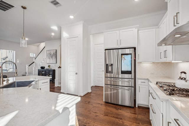 kitchen featuring light stone countertops, sink, stainless steel appliances, dark hardwood / wood-style flooring, and white cabinets