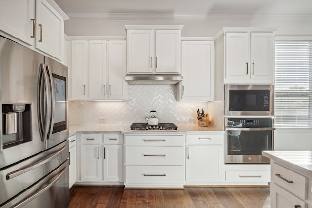 kitchen featuring white cabinets, appliances with stainless steel finishes, and dark wood-type flooring