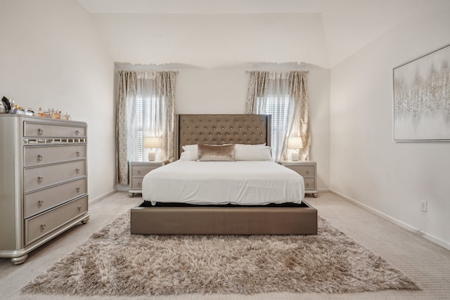 bedroom featuring multiple windows, carpet floors, and lofted ceiling