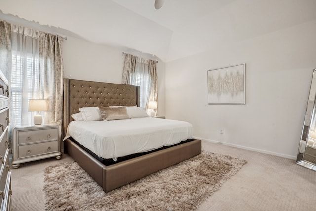 carpeted bedroom featuring lofted ceiling